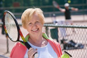 Smiling Senior Woman with Tennis Racket